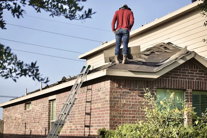 Professional roofer working on a residential roof in Chapel Trail